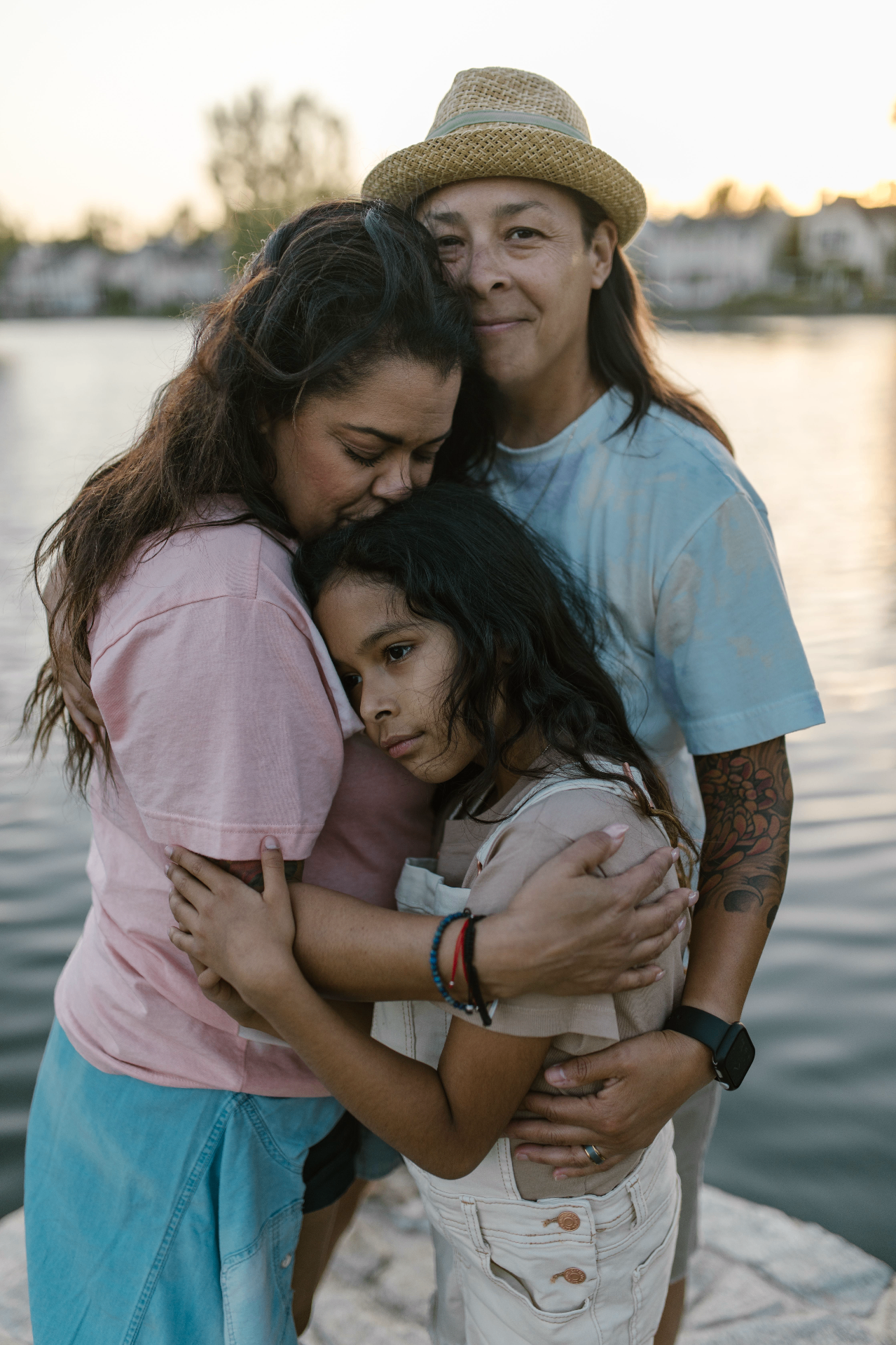 Family embracing at sunset